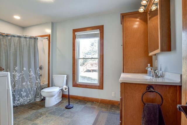 full bathroom with shower / bathtub combination with curtain, toilet, baseboards, washer / dryer, and vanity