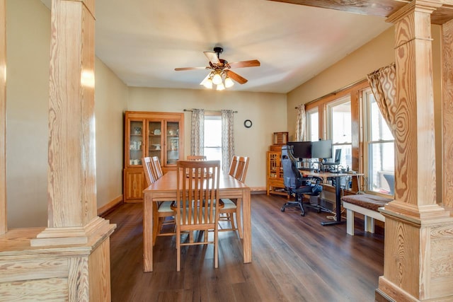 dining area featuring dark wood-style flooring, a ceiling fan, and decorative columns