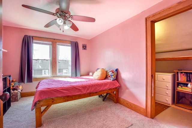 carpeted bedroom featuring a ceiling fan and baseboards