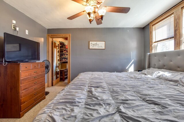 carpeted bedroom with a closet and ceiling fan