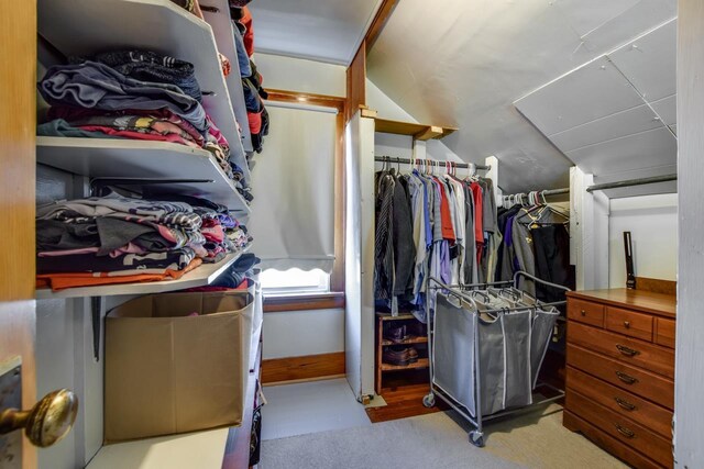 walk in closet featuring lofted ceiling