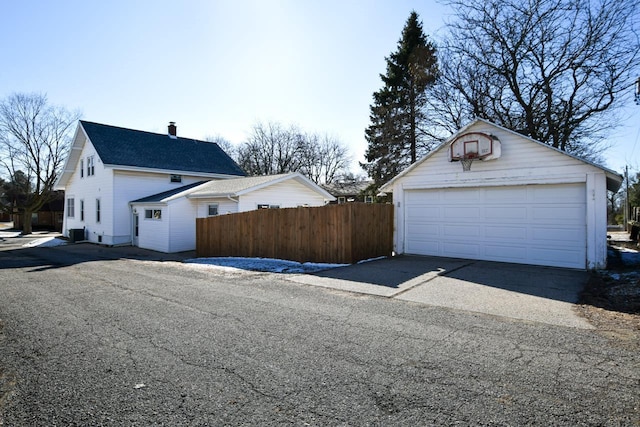 detached garage featuring fence