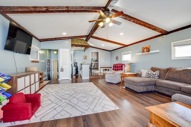 living room featuring lofted ceiling with beams, ceiling fan, and wood finished floors