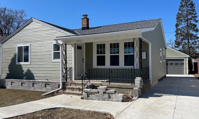 bungalow-style house featuring a garage, driveway, a porch, crawl space, and a chimney