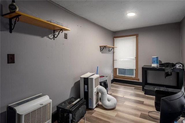 miscellaneous room featuring heating unit and light wood finished floors