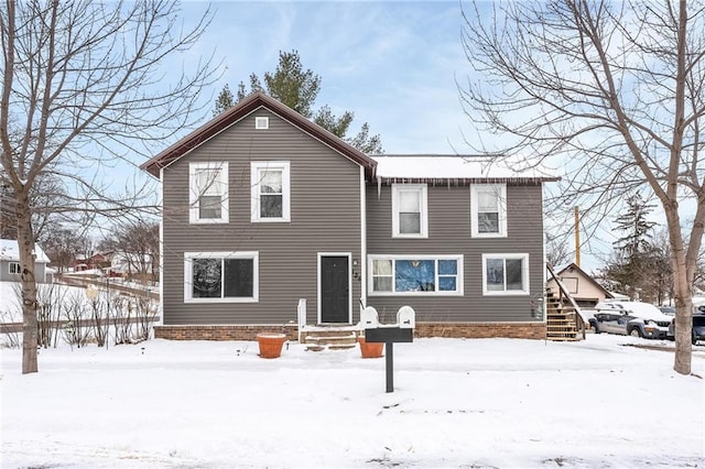 view of snow covered rear of property