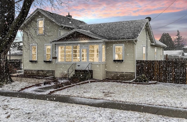 view of front of house with entry steps and fence