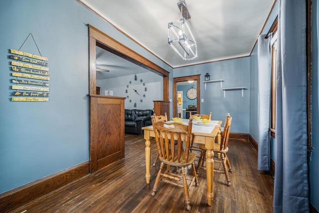 dining room with dark wood-type flooring and baseboards