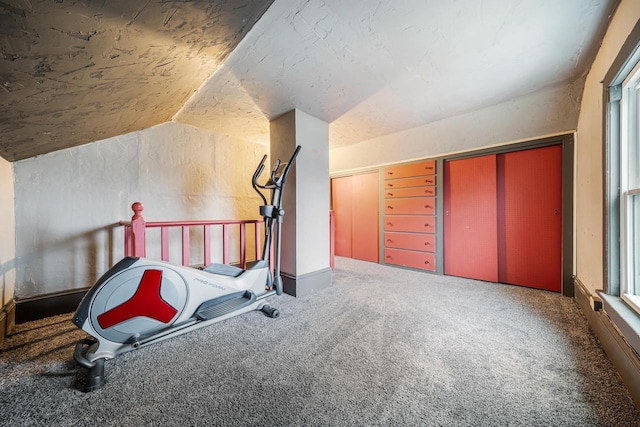 workout room with carpet and vaulted ceiling