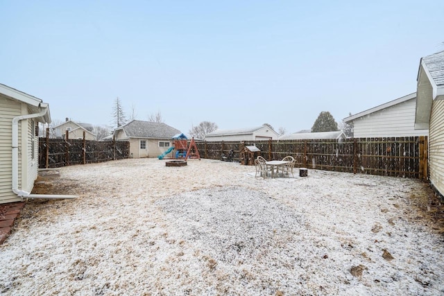 view of yard featuring a playground and a fenced backyard