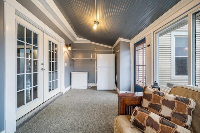 sitting room with crown molding, baseboards, lofted ceiling, carpet flooring, and french doors