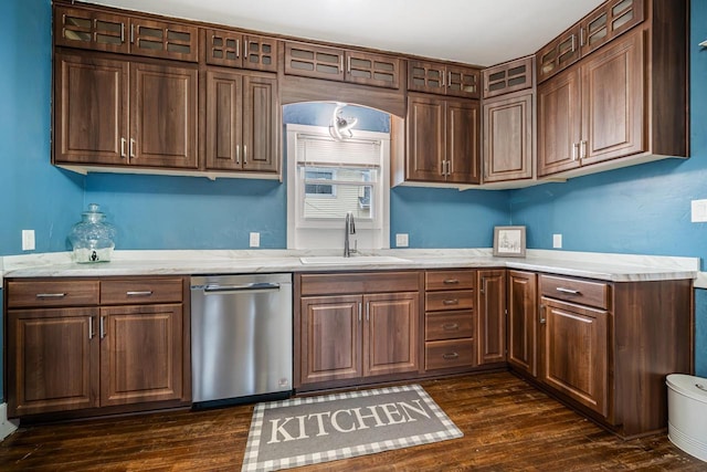 kitchen featuring a sink, glass insert cabinets, dishwasher, and dark wood finished floors