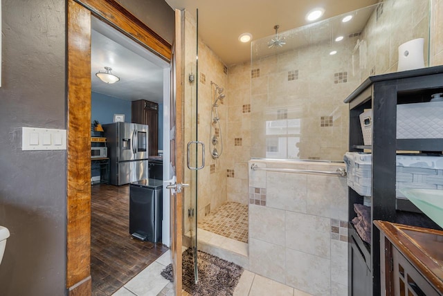 full bathroom featuring a stall shower and tile patterned flooring