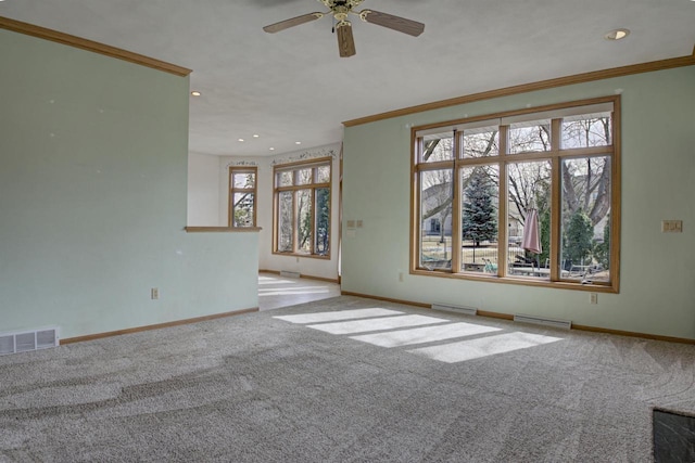 spare room featuring baseboards, visible vents, carpet floors, and ornamental molding