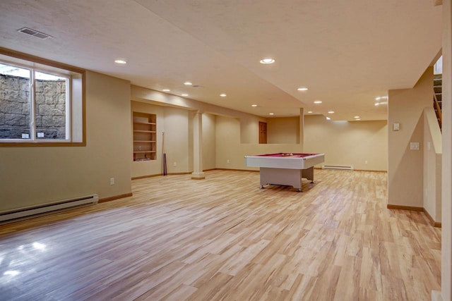 rec room with a baseboard heating unit, light wood-style flooring, and baseboards