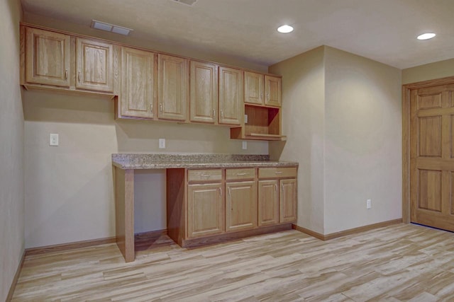 kitchen featuring recessed lighting, baseboards, light wood-style flooring, and light stone countertops