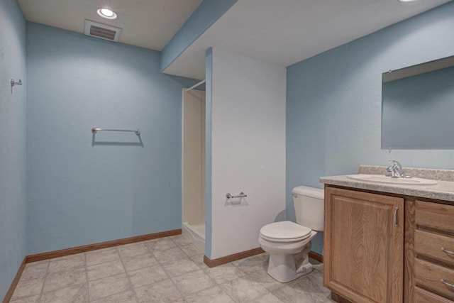 full bath featuring vanity, baseboards, visible vents, walk in shower, and toilet