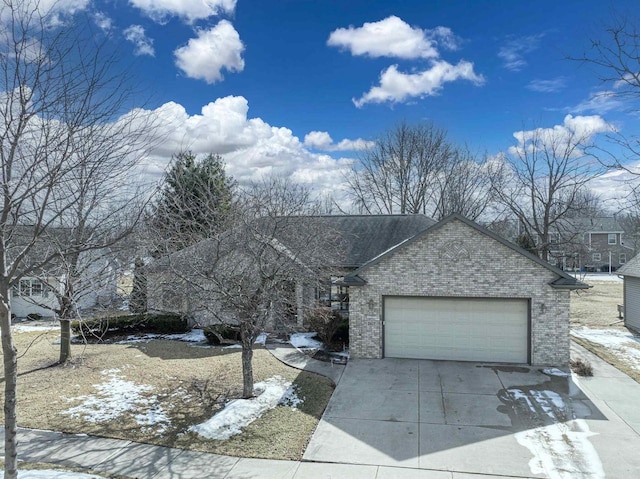 view of front of house featuring brick siding, driveway, a shingled roof, and a garage