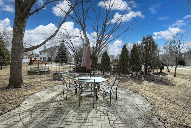 view of patio with outdoor dining area and fence