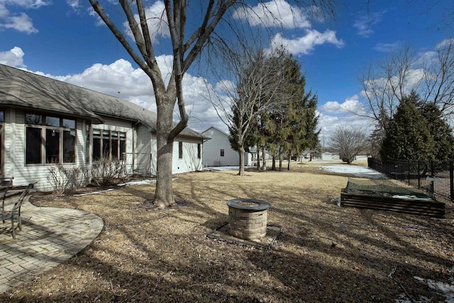 view of yard featuring a garden, a patio area, and fence