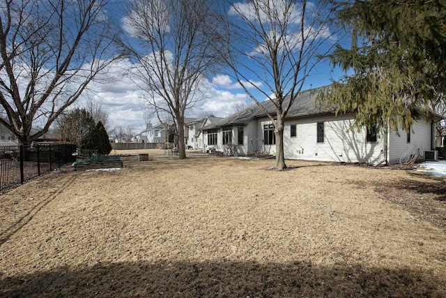 view of yard featuring central air condition unit and fence