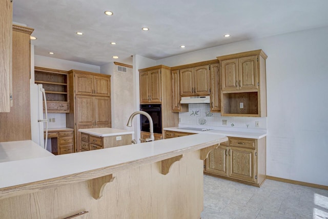 kitchen with open shelves, freestanding refrigerator, electric stovetop, under cabinet range hood, and black oven