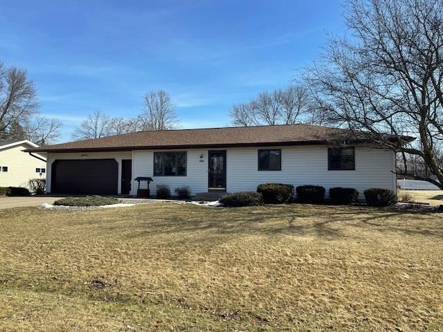 single story home featuring an attached garage, driveway, and a front yard