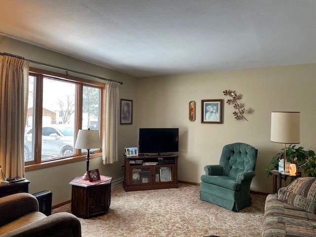 living room featuring light carpet and baseboards