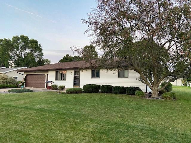 ranch-style house with a front yard and a garage