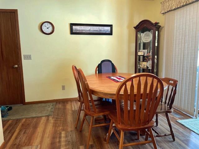 dining room with baseboards and wood finished floors