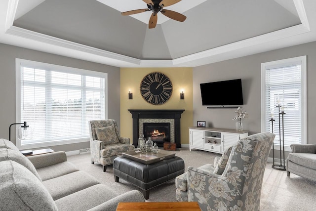 784 Westbridge Trl, Waunakee, WI 53597 - living area with a tray ceiling, light colored carpet, and a stone fireplace