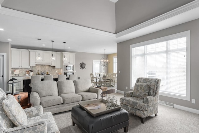 784 Westbridge Trl, Waunakee, WI 53597 - living room with visible vents, baseboards, light colored carpet, and an inviting chandelier