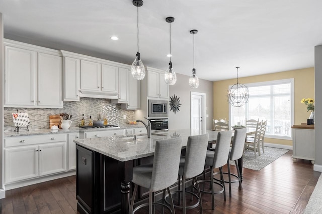 784 Westbridge Trl, Waunakee, WI 53597 - kitchen featuring backsplash, white cabinetry, stainless steel appliances, and a sink
