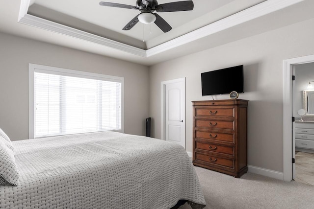 784 Westbridge Trl, Waunakee, WI 53597 - bedroom featuring connected bathroom, baseboards, a tray ceiling, light carpet, and a ceiling fan