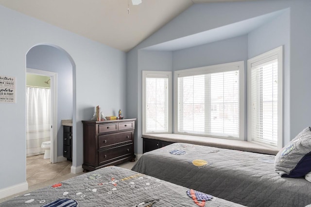 784 Westbridge Trl, Waunakee, WI 53597 - bedroom with lofted ceiling, baseboards, arched walkways, and ensuite bathroom