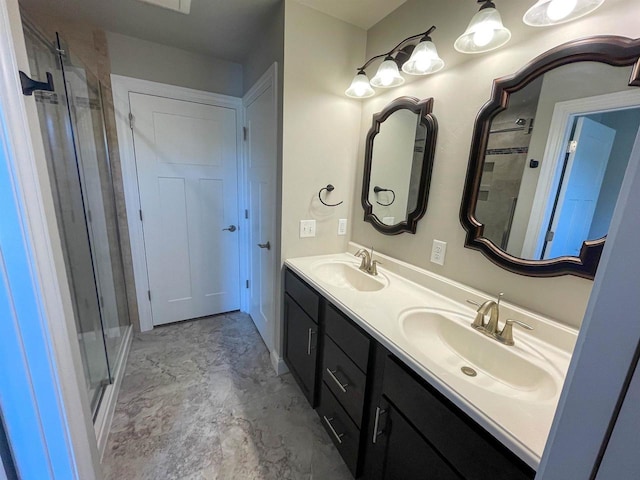 bathroom with double vanity, a stall shower, and a sink