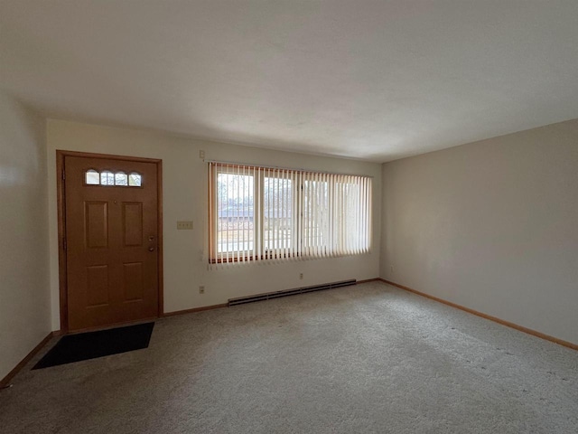 foyer entrance with light carpet, a baseboard heating unit, and baseboards