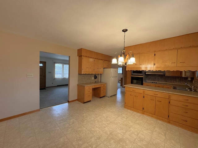 kitchen featuring a sink, black oven, light floors, and freestanding refrigerator