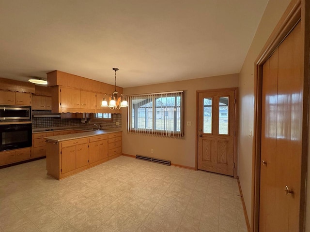 kitchen featuring stainless steel microwave, oven, a chandelier, light floors, and decorative backsplash