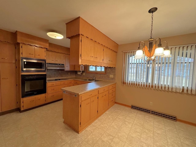 kitchen with light floors, a peninsula, a sink, black appliances, and under cabinet range hood