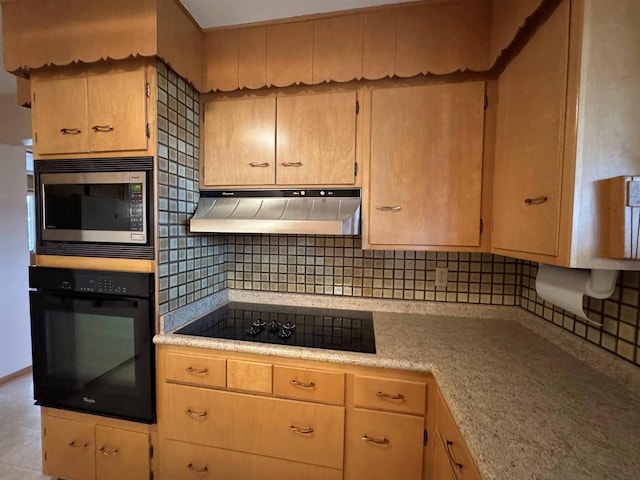 kitchen with baseboards, black appliances, light countertops, under cabinet range hood, and tasteful backsplash