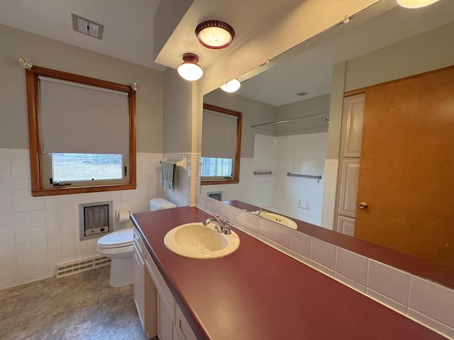 bathroom featuring vanity, tile walls, toilet, and visible vents