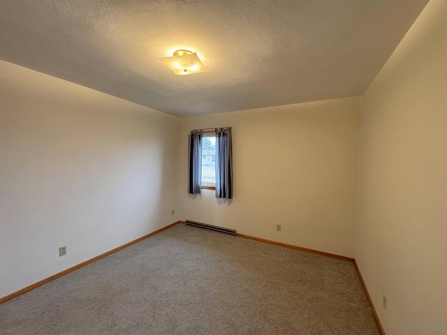 spare room featuring baseboards, light carpet, a textured ceiling, and a baseboard heating unit