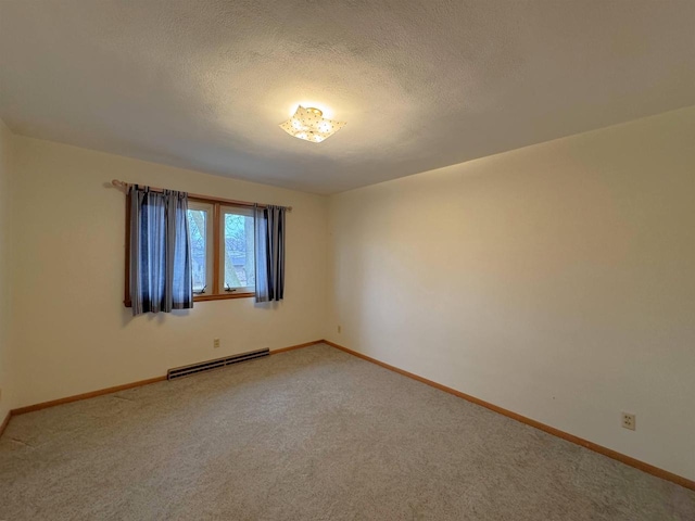 unfurnished room with a textured ceiling, baseboards, and a baseboard radiator