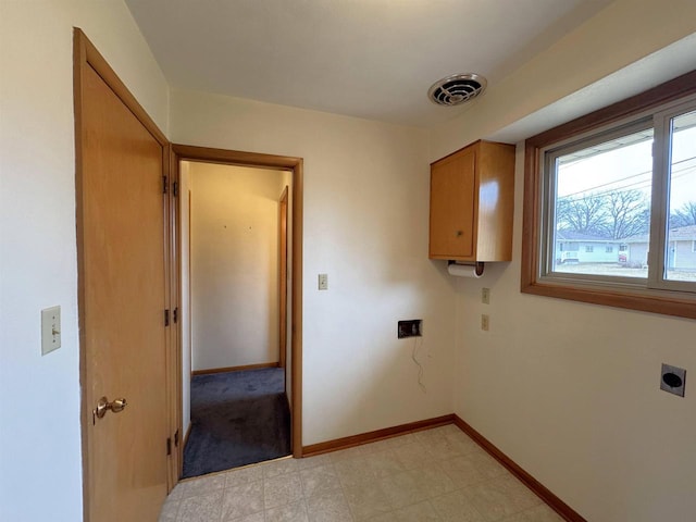 laundry room with electric dryer hookup, visible vents, cabinet space, baseboards, and light floors