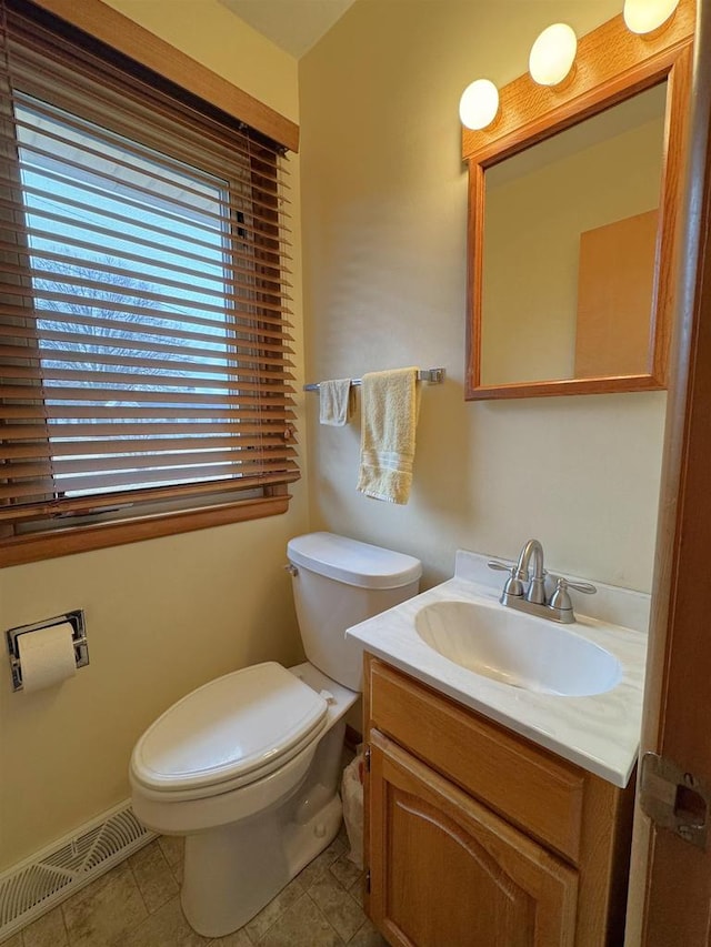 bathroom with vanity, toilet, visible vents, and tile patterned flooring