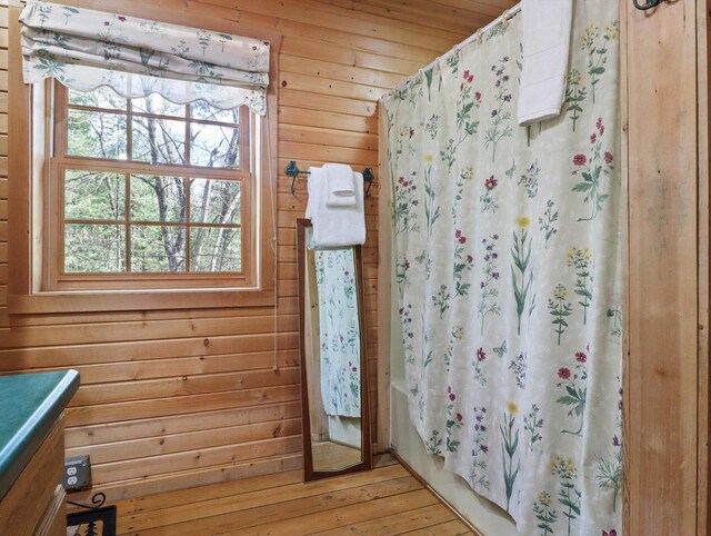 W3864 W Lemonweir Ct, Mauston, WI 53948 - bathroom featuring wood-type flooring, vanity, wood walls, and shower / bath combination with curtain