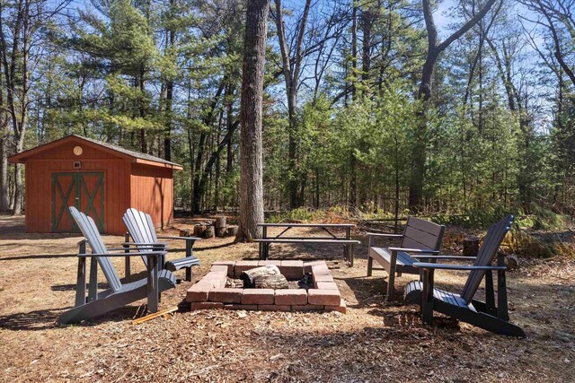 W3864 W Lemonweir Ct, Mauston, WI 53948 - view of yard featuring an outbuilding, a fire pit, and a storage unit