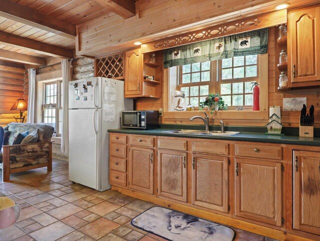 W3864 W Lemonweir Ct, Mauston, WI 53948 - kitchen featuring a sink, stainless steel microwave, open shelves, and freestanding refrigerator