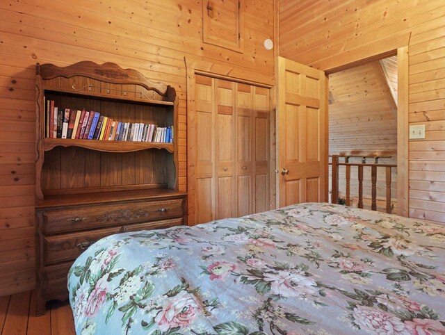 W3864 W Lemonweir Ct, Mauston, WI 53948 - bedroom featuring a closet, wood walls, and wood finished floors